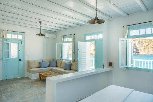 a living room with a couch and a table at Thavma Kalosyni in Firopótamos