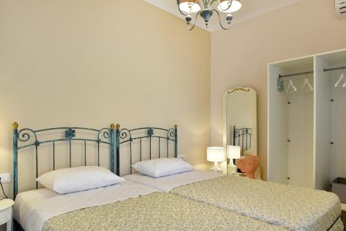 a bedroom with a bed and a large mirror at Giannis Papoutsis in Posidhonía