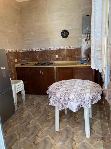 a small kitchen with a table and a counter at Azla Beach Escape - Cozy Apartment in Tétouan