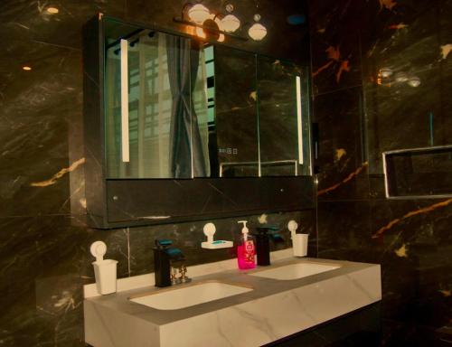 a bathroom with two sinks and a mirror at Villaveh Gameview in Nakuru