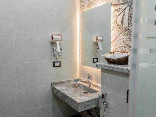 a bathroom with a sink and a mirror at Pool view- Luxurious 3BD Hotel Apt, Sheikh Zayed in Kafr Abū ʼumaydah