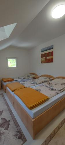 a bedroom with three beds in a room at Boračko Lake View Apartment "doelend" in Konjic