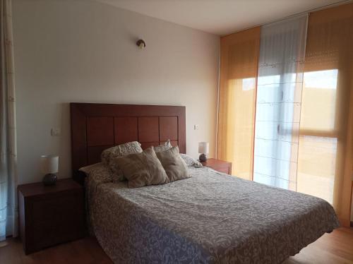 a bedroom with a bed with two pillows on it at La Vega in Cardeñadijo