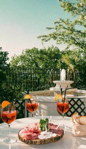 a table with wine glasses and a plate of food at B&B Camilla in Conca della Campania