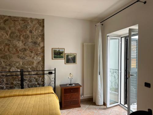 a bedroom with a yellow bed and a glass door at Antica Interamnia in Teramo