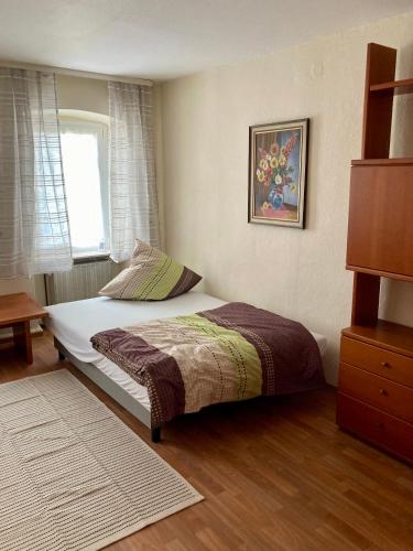 a small bedroom with a bed with a window at Ferienhaus Alter Hof in Volkach