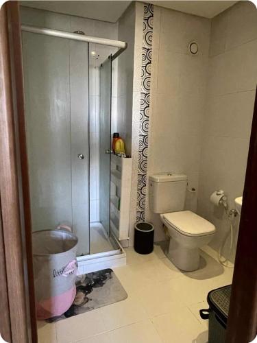 a bathroom with a toilet and a glass shower at Coin de Mire in Hammam Sousse