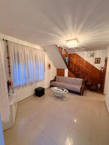 a living room with a couch and a table at Apartamani Evelin in Veliko Gradište