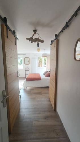 a bedroom with a bed and a door leading into a room at Chambre d'hôtes Bidegaina in Ahetze