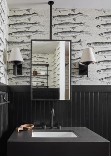 a bathroom with a sink and a mirror at All Seasons River Inn in Leavenworth