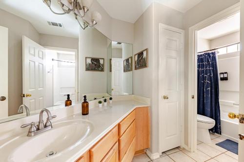 a bathroom with a sink and a toilet at Prospect Haus Stone Oak in San Antonio