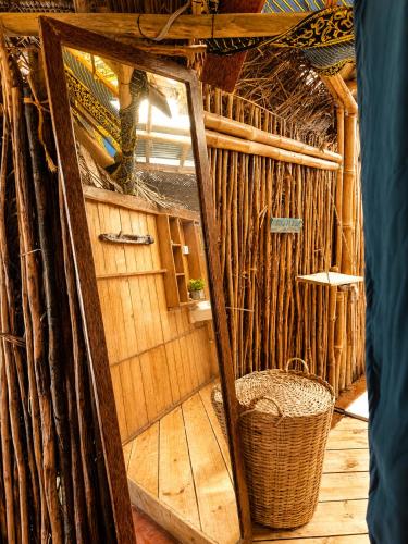 an inside view of a hut with a mirror at Karibuni Marafiki in Bwejuu