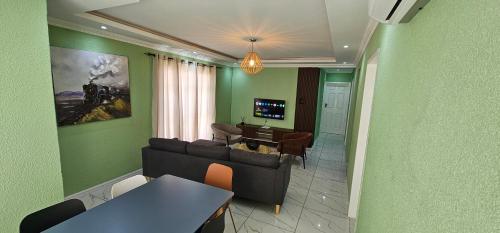 a living room with a couch and a table at Mountain-Ridge Lux Stay in Rustenburg