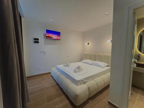 a bedroom with a large white bed in a room at Olive garden private Suite in Ksamil