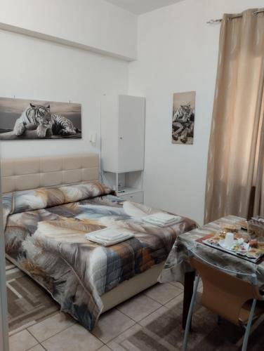 a bedroom with a bed and a table with a lamp at Sole Luna B&B in Pescara