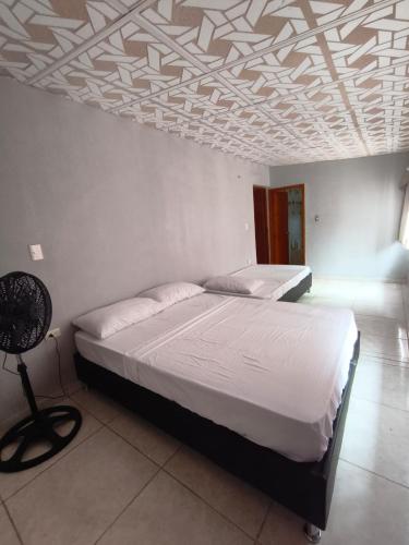 a bedroom with two beds and a coffered ceilings at Casa Finca la Casona con Piscina Privada - Cerca al Parque Tayrona in Santa Marta