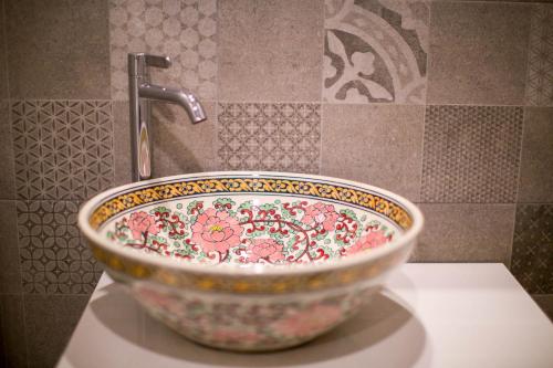 a bowl sitting on a counter in a bathroom at Vera Nidhra - Self check-in after 6pm in Bangkok
