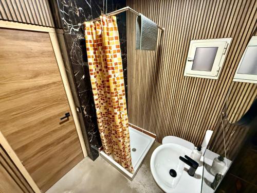 a bathroom with a sink and a toilet and a shower at The Orange Teddy Bear Gijón in Gijón