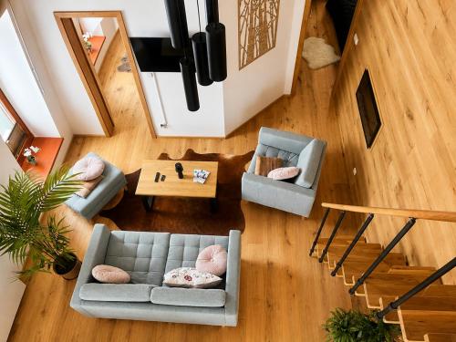 an overhead view of a living room with a couch and chairs at Apartmán 18 Lidická bouda in Pec pod Sněžkou