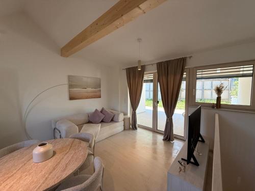 a living room with a table and a couch at Donau Vibes Luxury Family near City and Highway in Linz