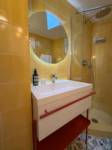 a bathroom with a sink and a mirror at Villa Sain Charming Suite in Anacapri