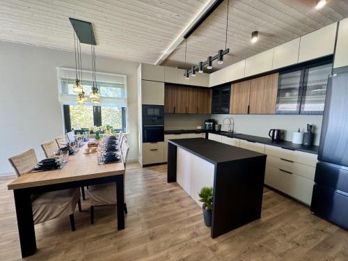 a kitchen with a table and a dining room at Dom Port Orion Puck in Puck