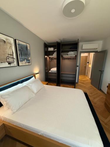 a bedroom with a large white bed in a room at Sofia Tech Park Apartments - Premium in Sofia
