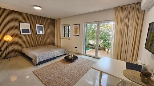 a bedroom with a bed and a large window at Maki Exclusive Apartments in Hvar