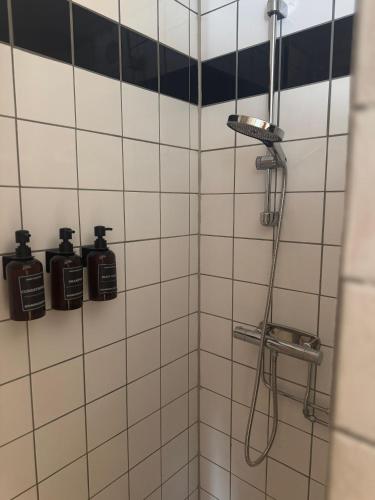 a bathroom with a shower with two bottles on the wall at Tiny house at Enhrna in Enhörna