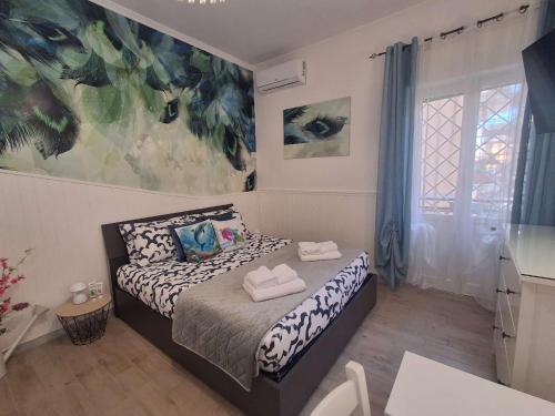 a bedroom with a bed with two towels on it at Roman sunset beach in Ladispoli
