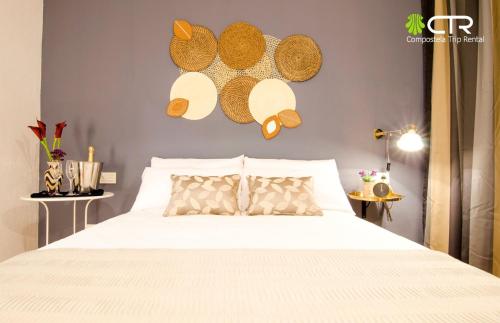 a bedroom with a bed with hats on the wall at Spacious & Central Apartament in Santiago de Compostela