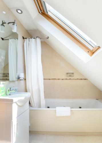 a bathroom with a bath tub and a sink at The Clubhouse in Sheffield