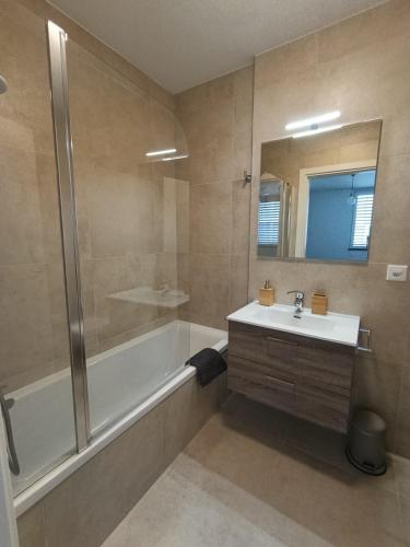 a bathroom with a tub and a sink and a shower at Funicolare 64 in Paradiso
