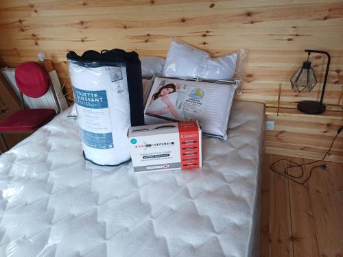 a bed with bags and boxes on top of it at Douglas in Saint-Racho