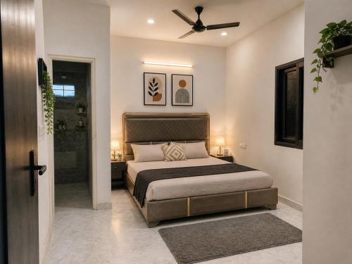 a bedroom with a bed with a ceiling fan at BTL Kamakshi homez , 3bhk free parking, open dining, balcony in Ludhiana