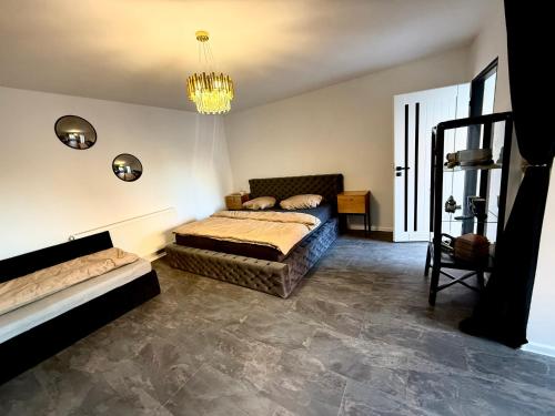 a bedroom with a bed and a chandelier at Self-Check- New Home in Levice