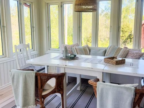 a dining room with a white table and chairs at 5 person holiday home in Häradsbäck in Ryd