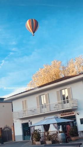 a kite flying in the sky above a building at Locanda Francini in Badia A Passignano