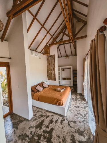 a bedroom with a bed in a room at Muara Surf House - Yoyos beachfront in Sekongkang