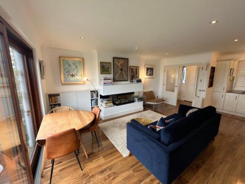 a living room with a blue couch and a table at 4 Harbour Town House in Westport