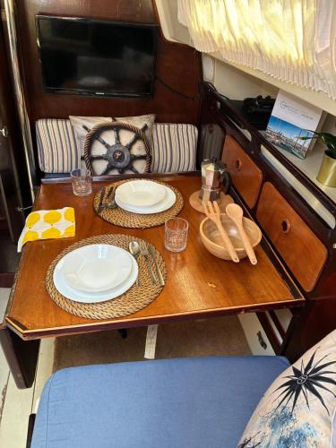 a wooden table with plates and dishes on it at Ulia in Arrecife