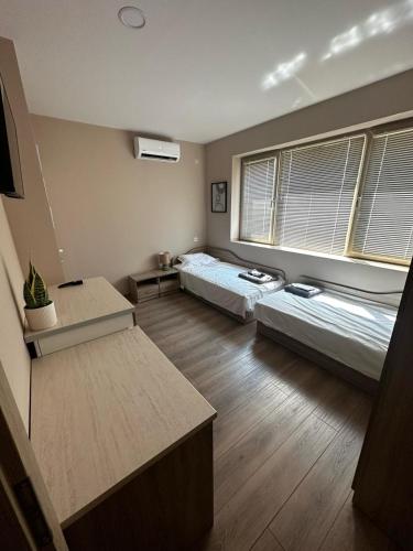 a large room with two beds and a table at Irene in Pawlikeni