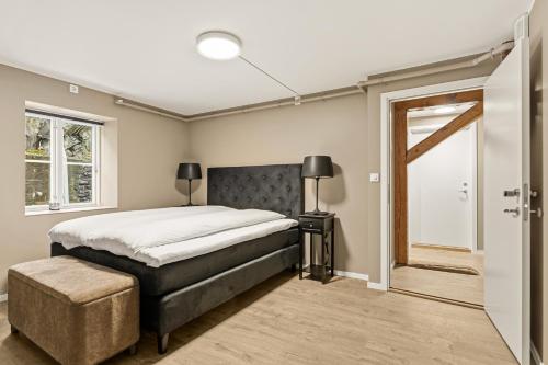 a bedroom with a large bed and a window at 2026 New built Aparthotel - 5 units - 4BR - 2BR - SKB17 in Bergen