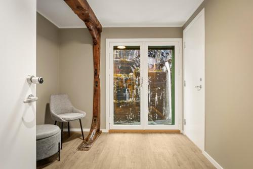 a room with a door and a chair and a window at 2026 New built Aparthotel - 5 units - 4BR - 2BR - SKB17 in Bergen