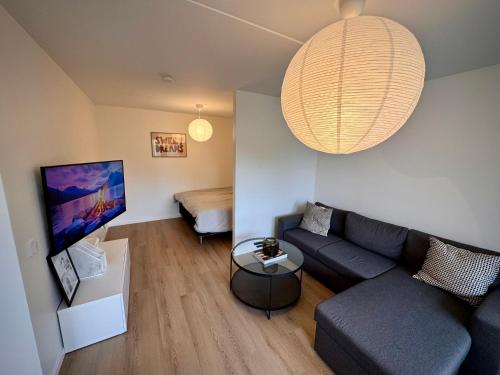 a living room with a couch and a table at Falkenbergsvägen 1C, Ullared in Ullared