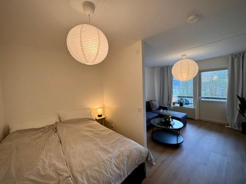 a bedroom with two lamps and a bed and a chair at Falkenbergsvägen 1C, Ullared in Ullared