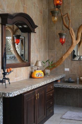 a kitchen with a counter with a sink and a mirror at Panáveda Ayurvedic Wellness Centre in El Creo