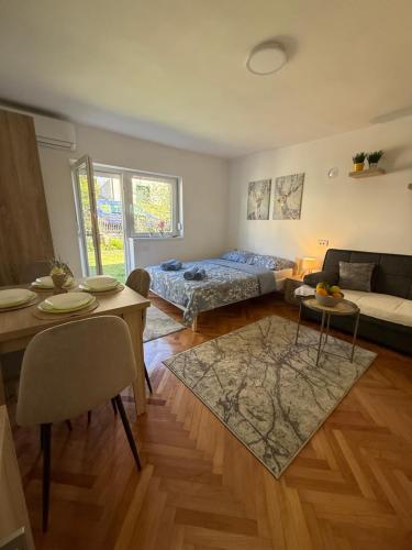a living room with a bed and a table at Mont in Rudnik