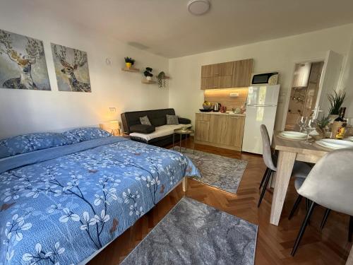 a bedroom with a blue bed and a kitchen at Mont in Rudnik
