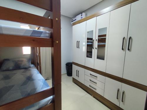 a bedroom with two bunk beds and cabinets in a room at Aluguel por Temporada Marabá - São Félix in Marabá